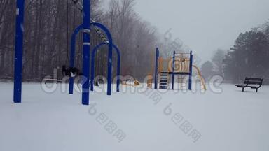 更明亮的版本*冬季降雪期间儿童`游戏公园。 在地上下雪的时候玩游戏